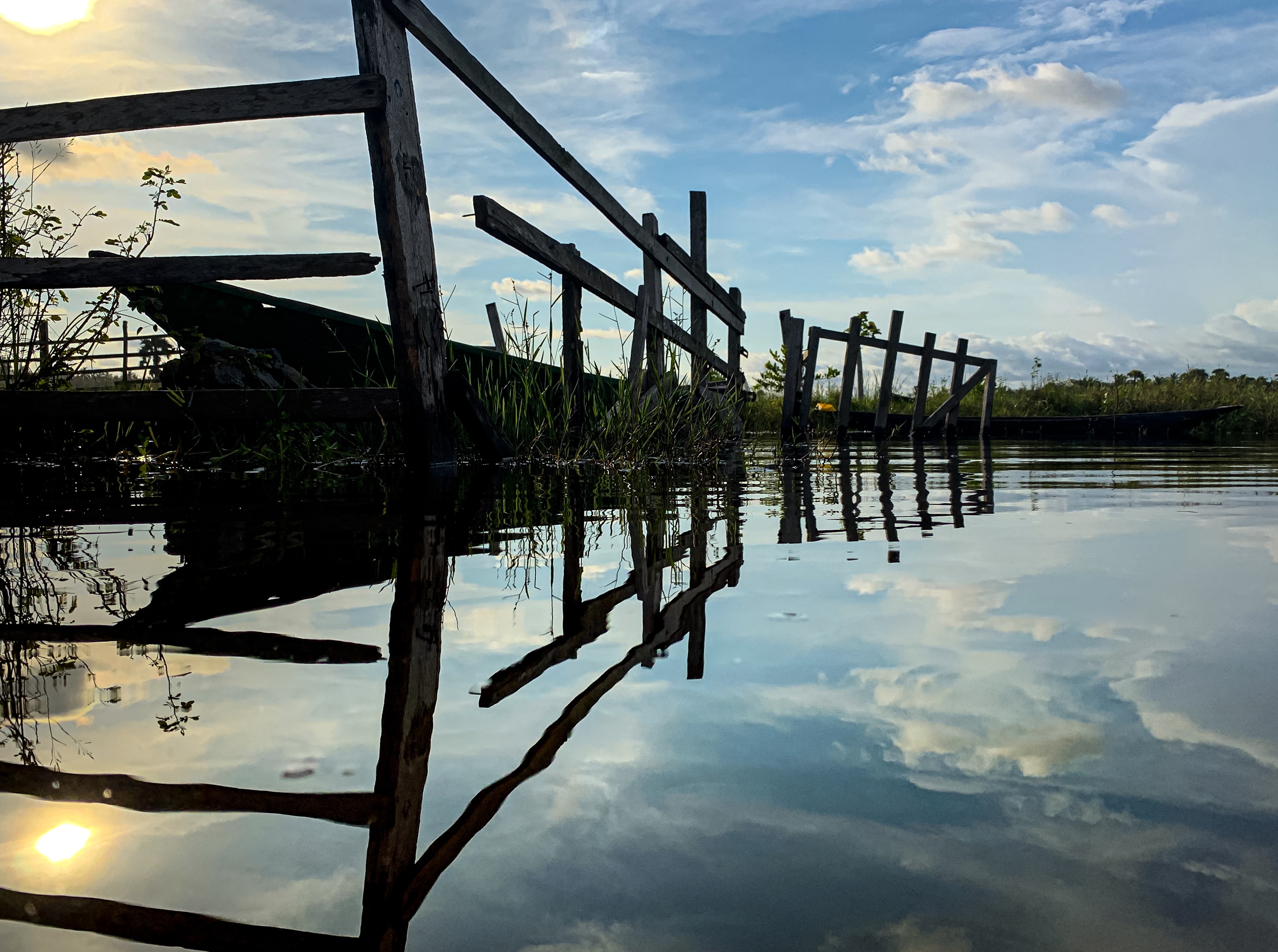 Pier on watter with reflection of sky